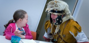 Young girl with man in old soldier garb